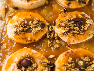 Apple pie on baking tray with caramel and nuts