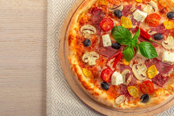 Pizza with Mozzarella, Ham, Cherry Tomatoes, Black Olives