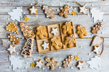 Homemade Christmas gingerbreads on a wooden background.
