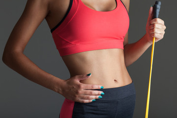 Young fitness woman. Closeup body shot