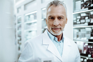 Cheerful gray-haired male person posing on camera