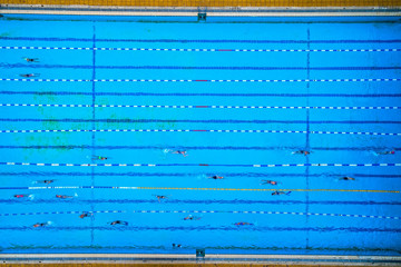 Aerial view of swimming pool with marked lanes and swimmers