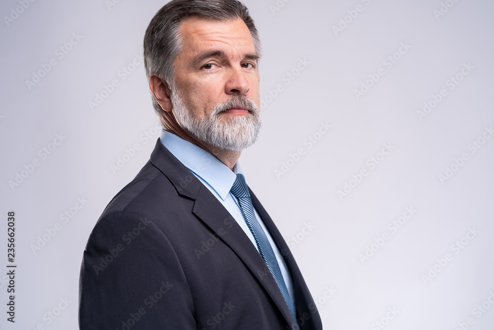 Wall mural happy satisfied mature businessman looking at camera isolated on white background.