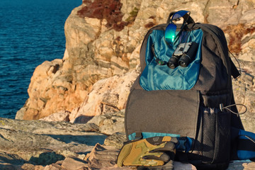  Photographer backpack against the background of rocks. Ready for adventure trip.