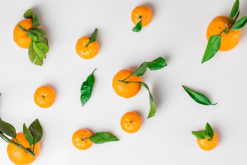 Background of fresh citrus with leaves on white. Flat lay. Top view