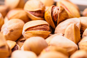 Close-up of pistachio. Selective focus on foreground.Pistachios texture. Nuts. Roasted salted pistachio nuts healthy delicious food studio photo.