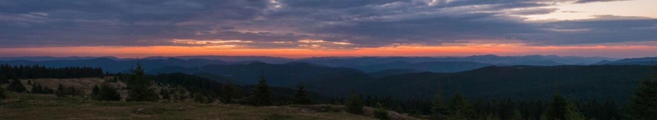 Naklejka premium Majestic pink and purple sunrise in the morning in the mountains. Amazing sunrise over Carpathian mountains in the summer. Panoramic morning scene.