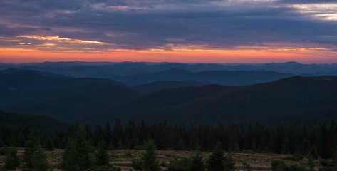Naklejka na ściany i meble Majestic pink and purple sunrise in the morning in the mountains. Amazing sunrise over Carpathian mountains in the summer. Panoramic morning scene.