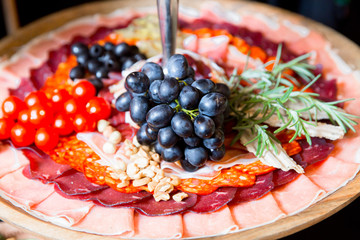 Antipasto catering platter with salami ,dry meat and grapes