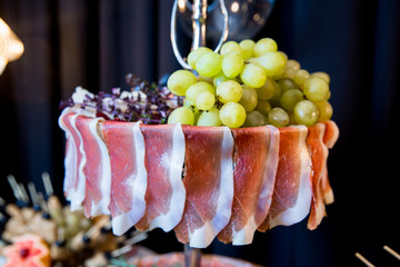 Antipasto catering platter with salami ,dry meat and grapes