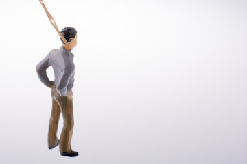 Man  figurine tied  with aa rope