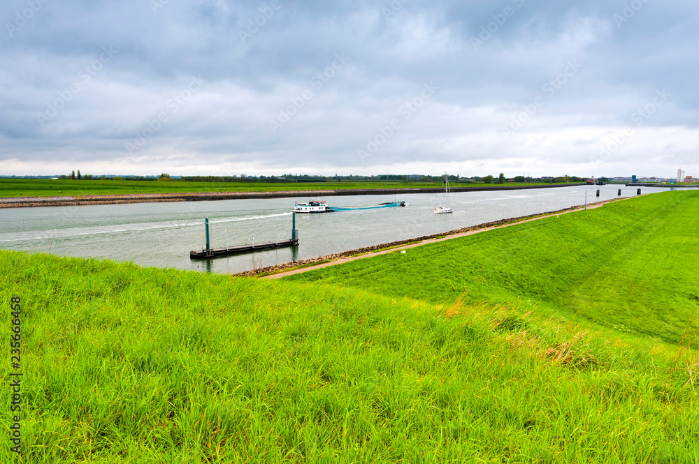 Canvas Prints barge and yacht navigating at canal in holland