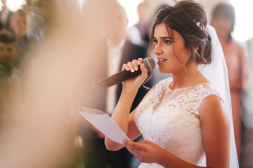 Young couple in church. Happy future family on ceremony. Groom and bride swear to love each other...