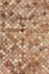 Colorful soft pastel monophonic Venetian mosaic as decorative decoration of facade. Venetian mosaic as decorative background. Selective focus. Abstract pattern. Abstract mosaic ceramic stones