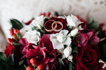 wedding bouquet of red roses and rings