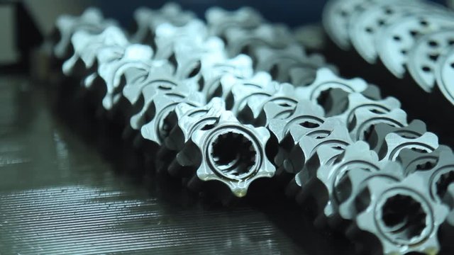 Machine tool parts manufacturing. Rows of metal billets with internal thread