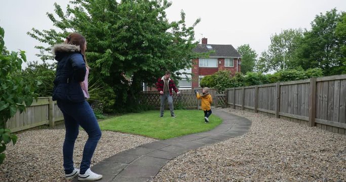 Mother Watching Husband and Their Son Play Fight