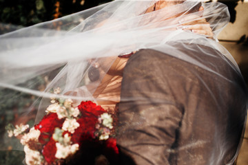 bride and groom with wedding bouquet of flowers