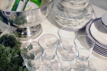 New year's interior. A small artificial Christmas tree with toys and candles. Glasses serving.