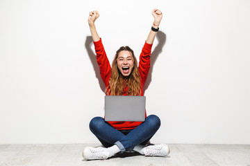 Portrait of an excited young woman wearing hoodie