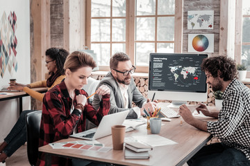 Attentive blonde female reading article in internet