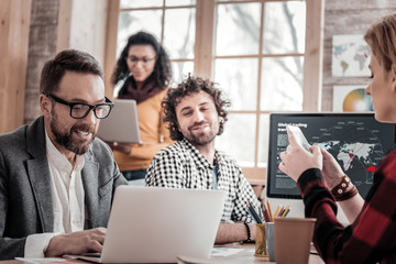 Positive delighted colleagues working at their project
