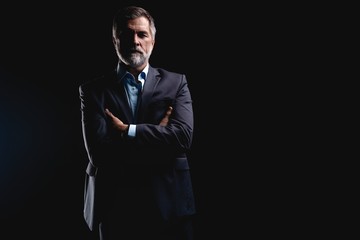 Handsome mature business man isolated on black background