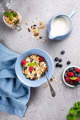 Homemade oatmeal granola or muesli with yogurt and fresh berries for healthy morning breakfast, selective focus. Healthy food background.