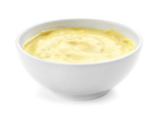 Tasty yellow sauce in bowl on white background