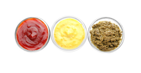 Different tasty sauces in bowls on white background