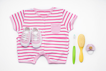Composition with clothes and baby care accessories on white background
