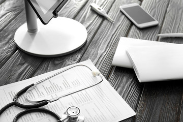 Laboratory test request form with stethoscope and computer on table. Health care concept