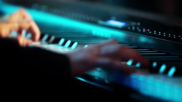 Color footage of some person playing the piano.