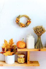 Autumn composition with dry leaves and ripe pumpkins