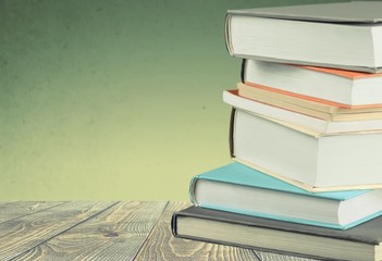 Stack of colorful books on blurred background