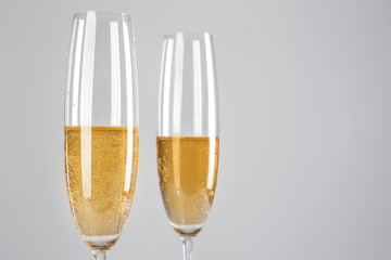 Glasses of champagne on grey background