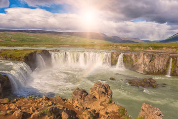 Godafoss (Akureyri) waterfall at sunny day, spectacular landscape of Iceland iconic place with blue cloudy sky. Skjalfandafljot river, Norðurland, North of Iceland