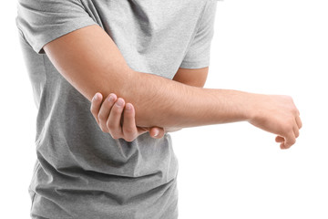 Young man suffering from pain in elbow on white background, closeup