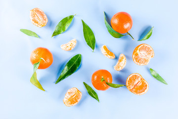 Fresh raw organic tangerines with leaves, top view flatlay copy space