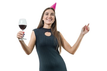 Happy smiling young woman with a glass of red wine, in party hats, black cocktail dress. On white isolated background girl having fun dancing