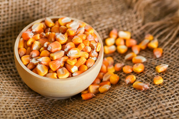 Close up corn seeds in bowl on beige cloth