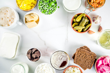 Super Healthy Probiotic Fermented Food Sources, drinks, ingredients, on white marble background copy space top view