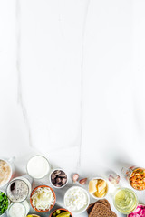 Super Healthy Probiotic Fermented Food Sources, drinks, ingredients, on white marble background copy space top view