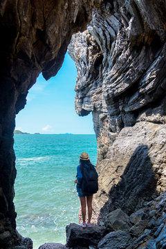 Travel people lifestyle women tourist in summertime and vacations trip in the cave near  sea in Keo Sichang, holiday tourist, Thailand. Travel Concept.