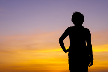 Fototapeta premium Young woman relaxing with sunset