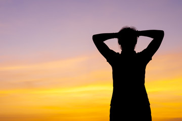 Fototapeta premium Young woman relaxing with sunset