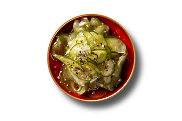 Sunomono - Japanese Cucumber Salad with sesame seeds. Isolated top view.