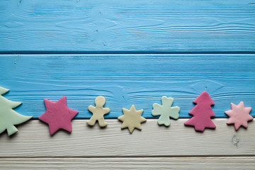 Colorful Christmas cakes on wooden background