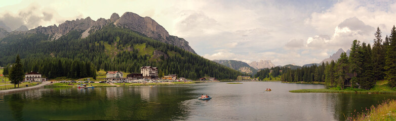 Fototapeta premium Auronzo di Cadore, Italy August 9, 2018: Misurina Mountain Lake. Beautiful tourist place with houses and cafes.