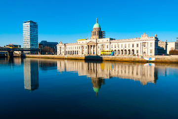 Custom House and Liberty Hall reflecting on river Liffey in Dublin